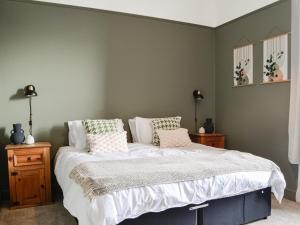 a bedroom with a bed with white sheets and pillows at Main Street Flat A - Uk46448 in Ayr