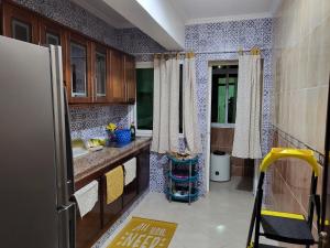 a kitchen with a sink and a refrigerator at Zemmouri 3 in Tangier