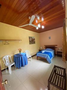 a bedroom with a bed and a table and chairs at KILLA Casa Hospedaje in Iquitos