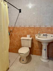 a bathroom with a toilet and a sink at Casa del Sol in Pátzcuaro