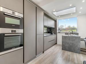 a kitchen with stainless steel appliances and a counter at Gateway Retreat in Barrowford