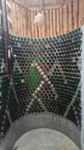 a wall of wine bottles on a wall at Nature Hill in Koh Mook