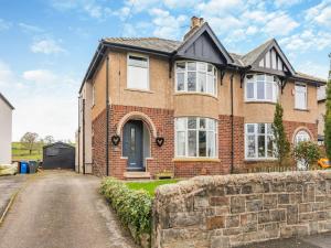 a brick house with a stone wall at Gateway Retreat in Barrowford