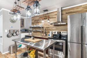 a kitchen with stainless steel appliances and wooden walls at Salt Block - The Rustic Suite 1 in Bandera