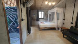 1 dormitorio con cama blanca y sofá en Nature Hill, en Ko Mook