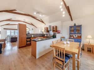 una cucina con tavolo in legno e una sala da pranzo di Crosscombe Barn a Loddiswell