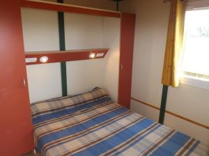Habitación pequeña con cama y ventana en Gîte Maurs, 3 pièces, 4 personnes - FR-1-742-536, en Maurs
