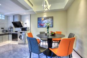 a kitchen and dining room with a table and chairs at Guilin Yangshuo Waterhouse River View Villa in Yangshuo