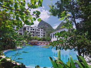 a view of the swimming pool at the resort at Guilin Yangshuo Waterhouse River View Villa in Yangshuo