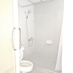 a bathroom with a shower with a toilet at Omni Suites Serviced Apartment in Bangkok