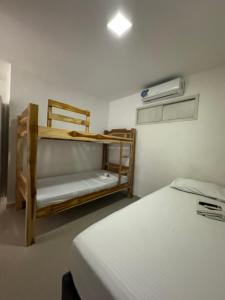 a bedroom with two bunk beds and a fan at Hotel Balcones del Sinu in Lorica