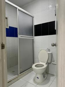 a bathroom with a toilet and a shower at Hotel Balcones del Sinu in Lorica