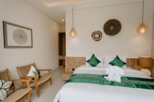 a bedroom with a bed with a bow on it at The Pahala Villas in Nusa Dua