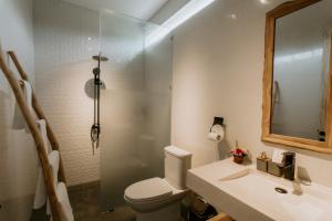 a bathroom with a toilet and a sink and a mirror at The Pahala Villas in Nusa Dua +15 photos