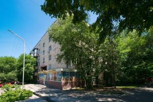 a building with a tree in front of it at Nadezhda Apartments on Zhibek Zholy Avenue 33 in Almaty