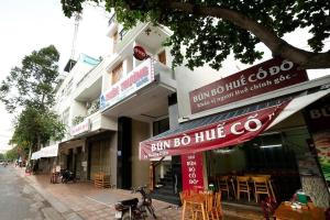 a building with a sign for a restaurant with tables at Thien Truong Hotel in Nha Trang