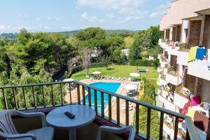 a balcony with a view of a swimming pool at Aparthotel Las Mariposas in Lloret de Mar