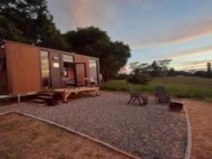 a tiny house sitting on top of a gravel yard at Little Jogo 