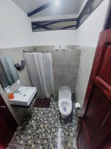 a bathroom with a toilet and a sink at Villa Los Altos - Private Tree Suite Roof Top walk to Playa Chiquita in Cocles