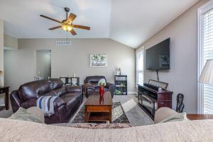 a living room with a leather couch and a tv at ~It's a Gem~Comfy Hideaway for R&R ~King Bed!~ in Columbia