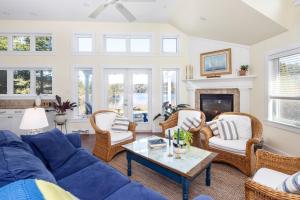 uma sala de estar com um sofá azul e cadeiras em The Nest at Deep Cove em Chester