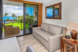 a living room with a couch and a view of the ocean at KIHEI SURFSIDE, #512 condo in Wailea +29 photos
