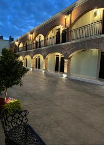 a building with a bench in front of it at Hotel Posada Real in Lagos de Moreno