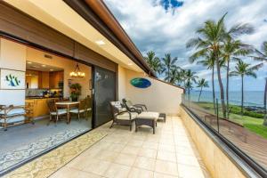 a balcony with a view of the ocean at MAKENA SURF, #E-303 condo in Wailea
