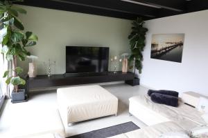 a living room with a large flat screen tv at Residence in Chieming