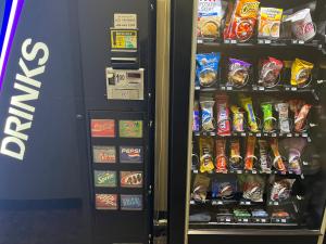 a black vending machine filled with lots of snacks at Americas Best Value Inn Kalispell in Kalispell