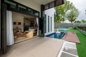 an open door of a house with a swimming pool at Bungalow Putrajaya 15pax w Private Pool Gathering in Putrajaya