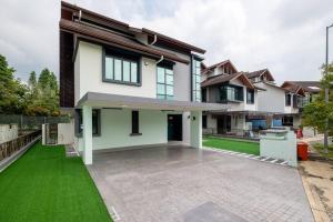 a house with a green lawn in front of it at Bungalow Putrajaya 15pax w Private Pool Gathering in Putrajaya