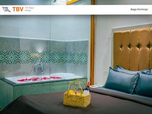 a bathroom with a tub and a basket of fruit on a table at Beach Doorz Place-TBV in Baga