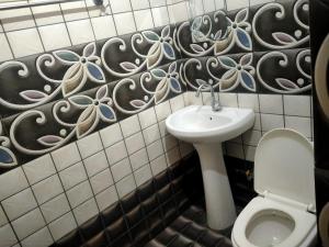 La salle de bains est pourvue de toilettes et d'un lavabo. dans l'établissement ANGAD RESIDENCY, à Amritsar