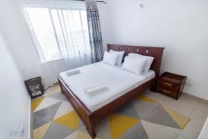 a bedroom with a bed and a window at Elegant and classy stay in Shanzu