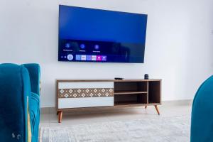 a living room with a tv on a wall at Elegant and classy stay in Shanzu