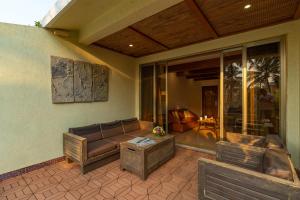 a living room with a couch and a table at Adamo The Bellus Calangute in Calangute