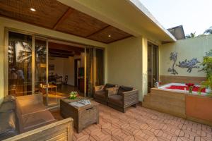 a patio with a jacuzzi tub on a house at Adamo The Bellus Calangute in Calangute