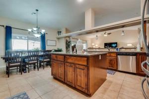 a large kitchen and dining room with a dining table at HavaCabana Pool Spa Games Lake View Garage in Lake Havasu City