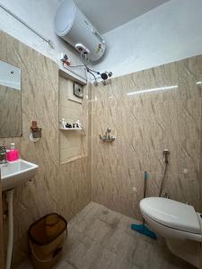 a bathroom with a white toilet and a sink at Aqua De Vida in Bhowāli +214 photos