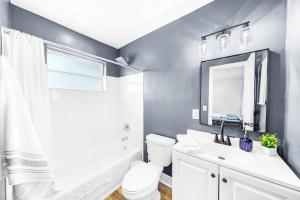 a bathroom with a toilet and a sink and a mirror at Water Front Condo - First Floor - Palm Wave Says in Coconut Creek +24 photos