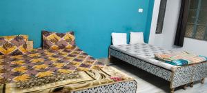 two beds sitting next to each other in a room at Welcome paying guest house in Varanasi