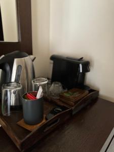 a tray with a coffee maker on a table at Cetatuia in Măgura