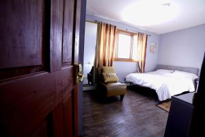 a bedroom with a bed and a window and a door at ShaligoHomes in Anchorage