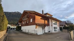 a house with a wooden roof and a driveway at Apartment on Zugspitzstrasse in Garmisch-Partenkirchen