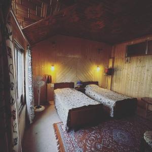 1 dormitorio con 2 camas en una habitación en Queens Lakehouse en Srinagar