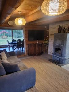 a living room with a couch and a fireplace at Jōekalda in Langa