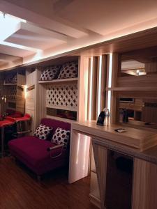 a room with a purple chair and a wine cellar at Grandboutique-Inn in Jakarta