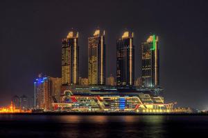 a group of tall buildings in a city at night at Grandboutique-Inn in Jakarta