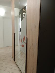 a glass door with a face on it in a hallway at RESIDENZA Giulia e Marco in Cesate